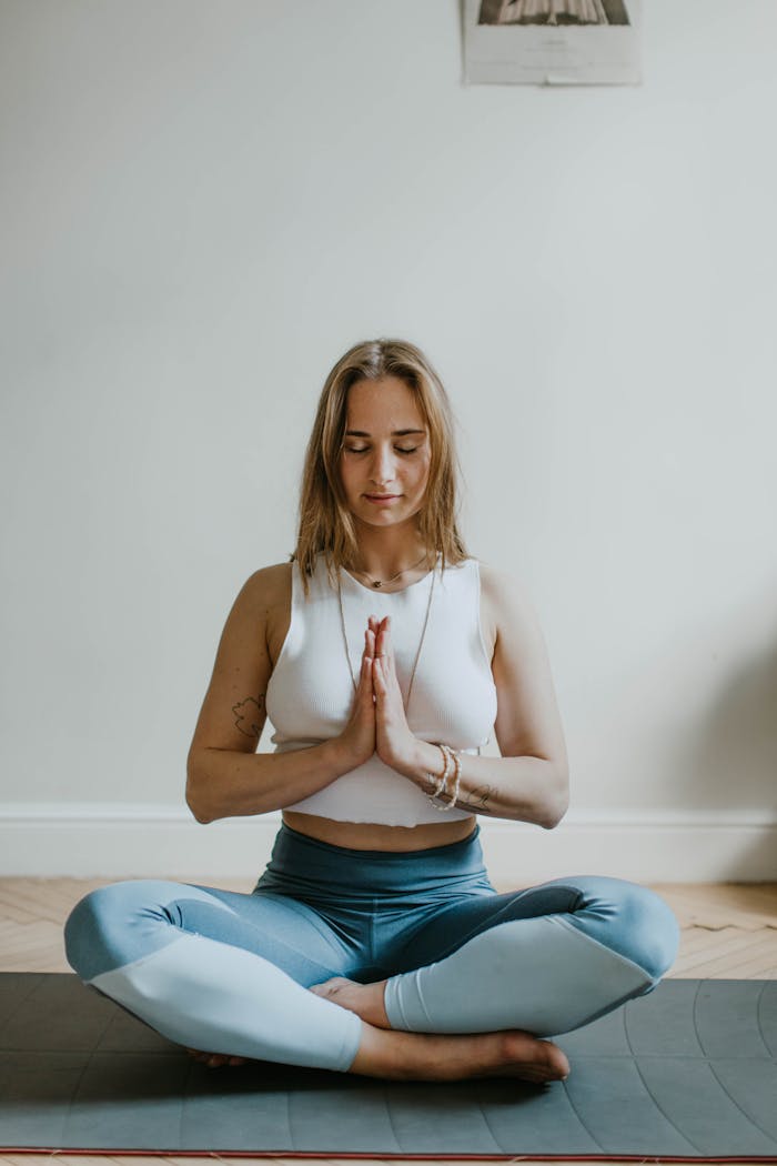 The Health Monk - A serene image of a woman practicing meditation indoors, promoting mindfulness and wellbeing.